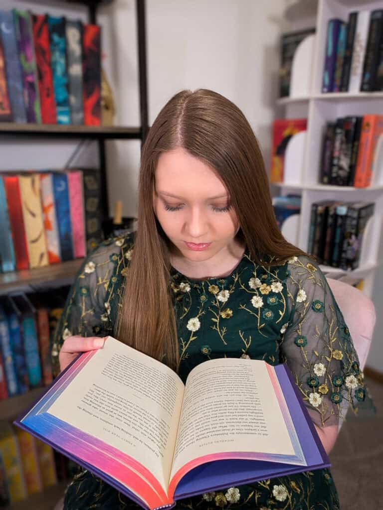 woman with an open book reading the words on the page