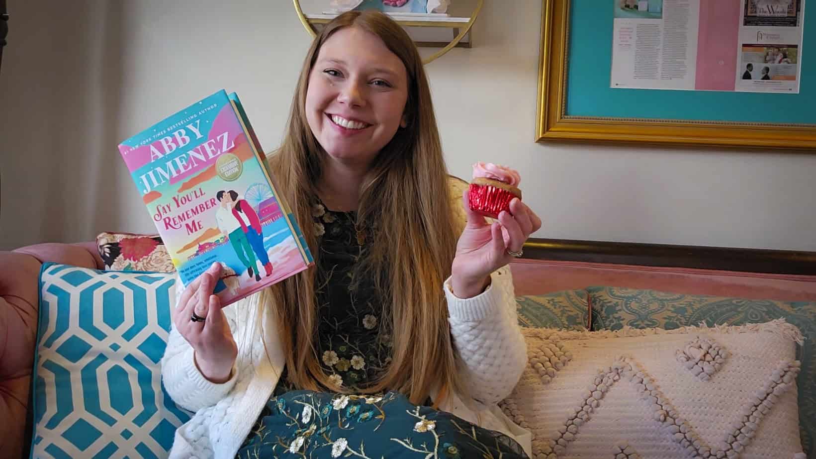Sierra at Nadia Cakes hold a copy of Say You'll Remember Me.