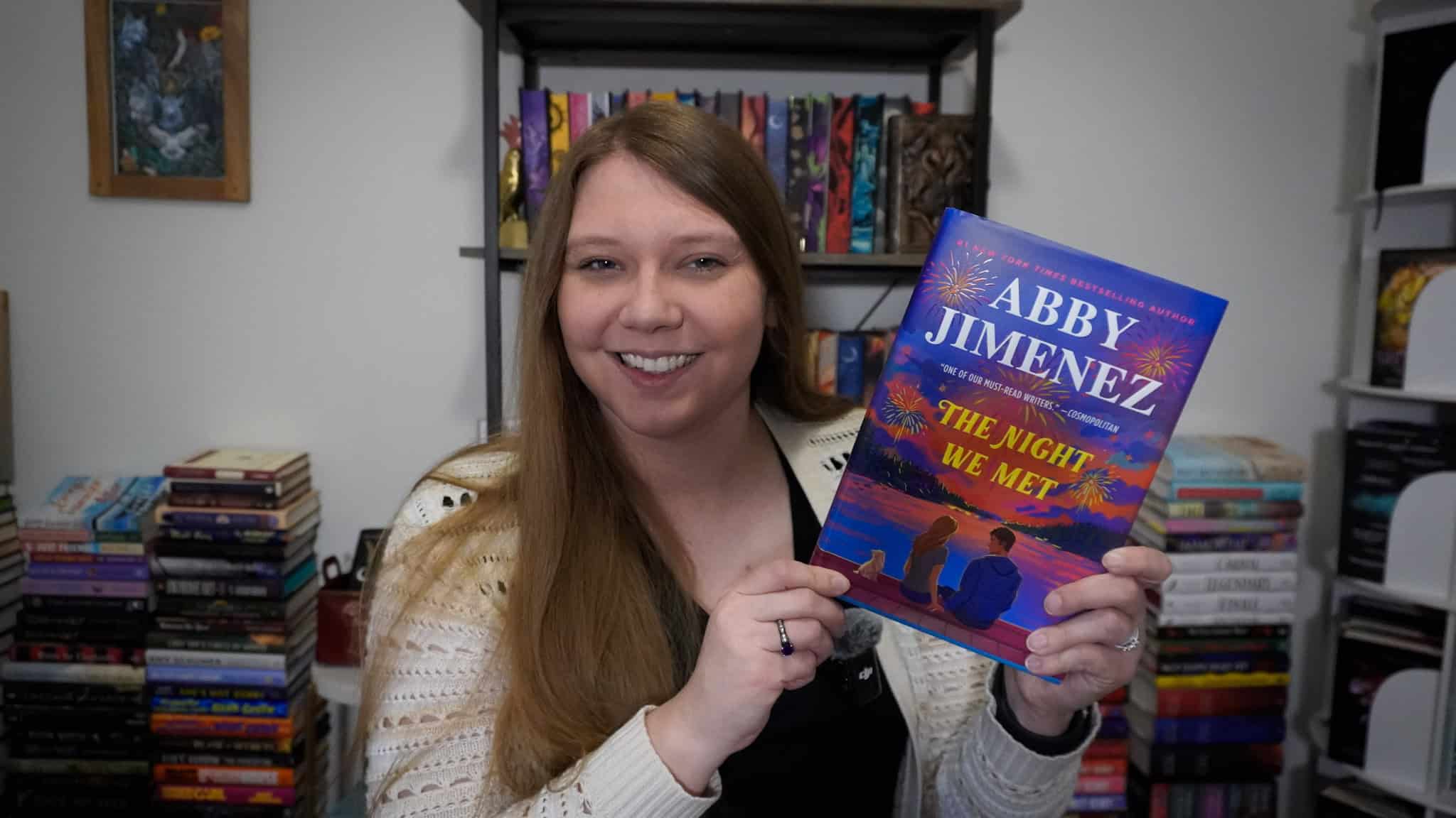 Sierra holding a copy of The Night We Met by Abby Jimenez