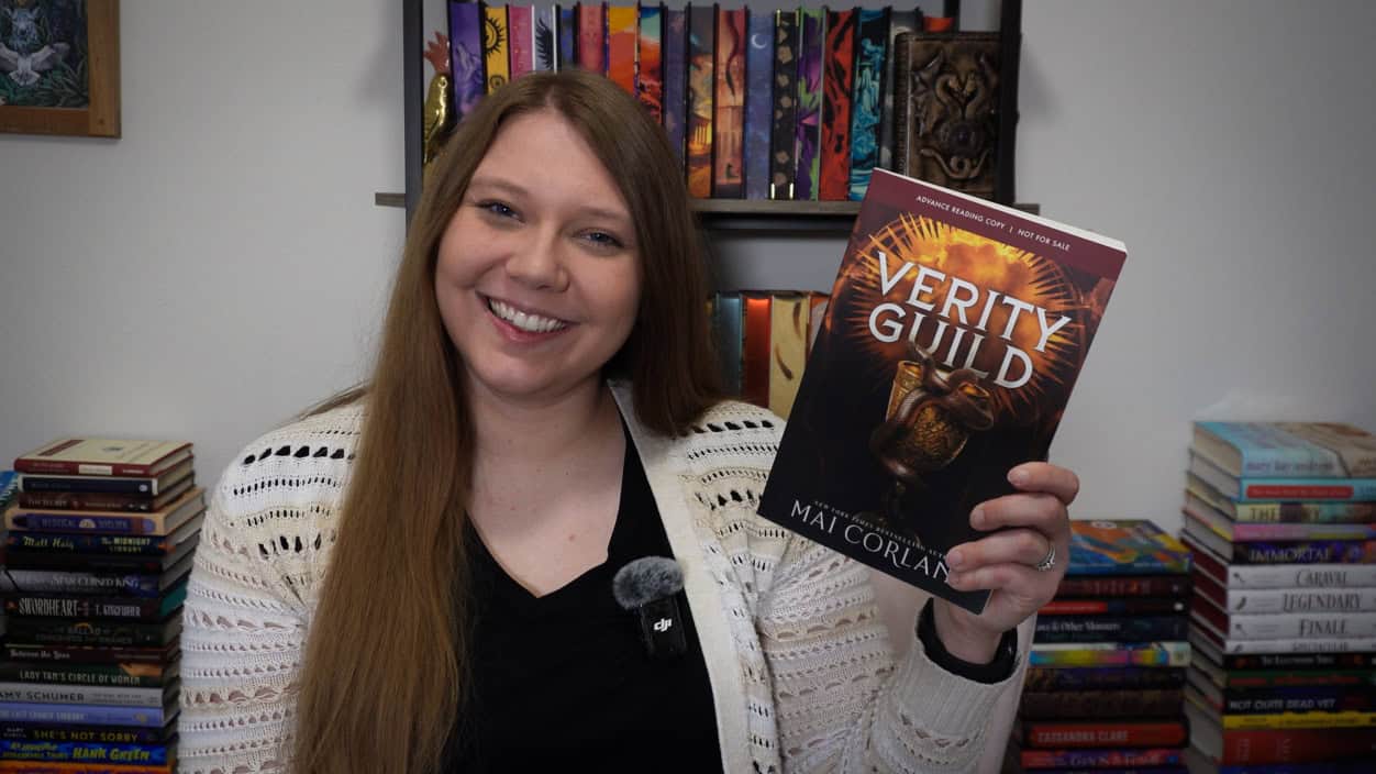 Sierra holding a advanced reader copy of Verity Guild by Mai Corland