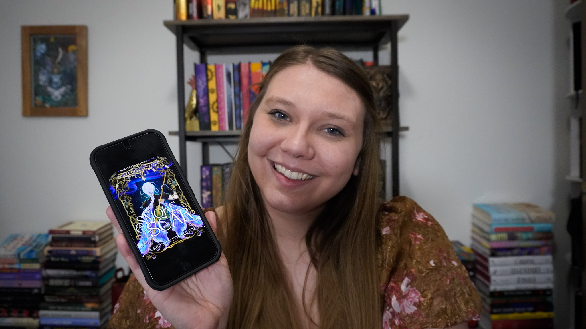Sierra holding her digital copy of Smoke and Scar by Gretchen Powell