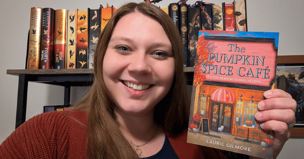 Sierra holding her copy of the pumpkin spice cafe